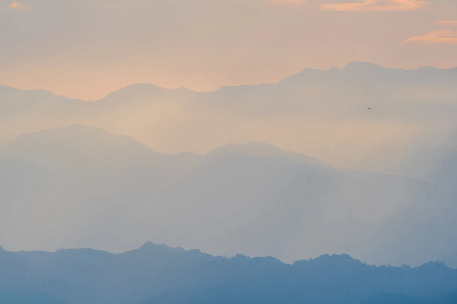 A calm, misty landscape at sunrise