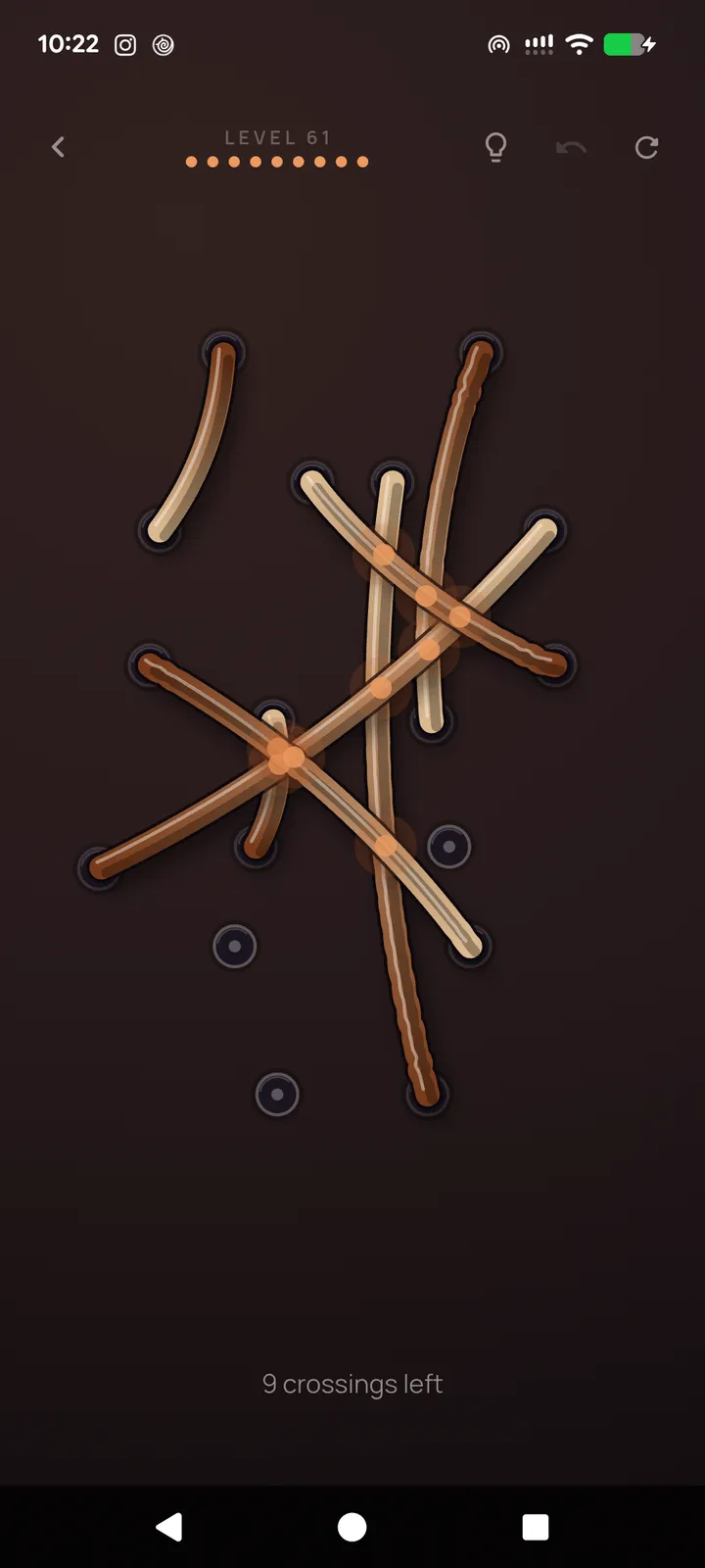 Untangle rope puzzle board with several brown ropes crossing and nine crossings left